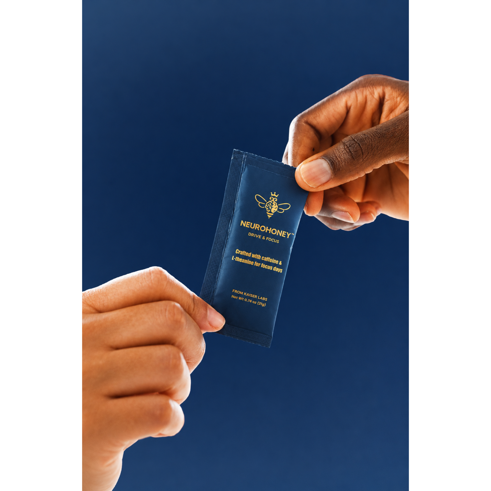 Two hands holding a small blue Neurohoney sample packet against a dark blue background.